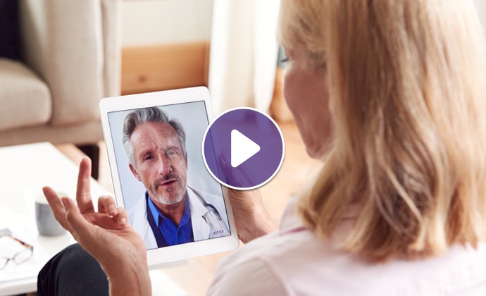 A woman talks with a physician via iPad